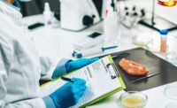 lab person with a clipboard analyzing ingredients