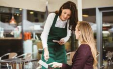 waitress handing the bill to the customer