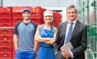 Team of warehouse staff and a manager in a food processing facility