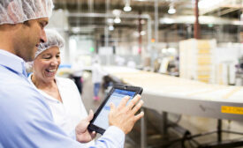 Meat & Poultry Workers Look at Tablet