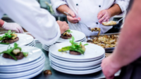 restaurant kitchen workers plating food