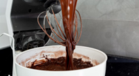 chocolate batter in a bowl on a stand mixer