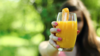 person holding OJ