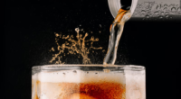 soda being poured out of a can into a glass