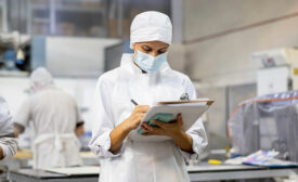 food safety auditor looking at clipboard