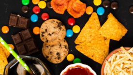 assortment of processed food- chips candy cookies soda fries ketchup