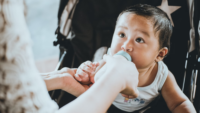 baby looking up while being bottle fed