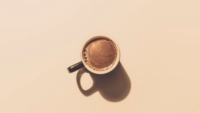 birds eye view of cup of coffee against beige background