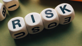 boggle tiles spelling out the word risk