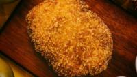 breaded chicken product on cutting board