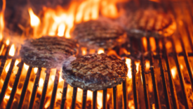 burger patties on grill flame