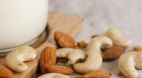 cashews and almonds next to jar of milk