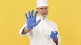 chef holding up food handling glove to camera