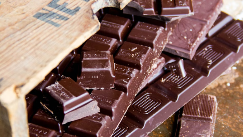 dark chocolate squares spilling out of wood crate