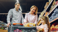 family of three grocery shopping