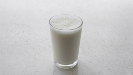 glass of milk on white counter