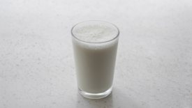 glass of milk on white counter