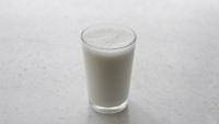 glass of milk on white counter