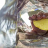 hand pulling potato chip out of bag