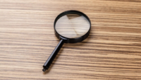 magnifying glass on wooden background