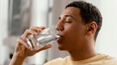 man drinking glass of water