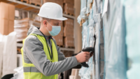 man scanning box in warehouse