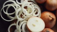 raw cut and whole yellow onions