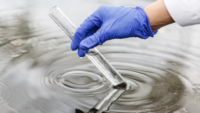 researcher holding test tube in water