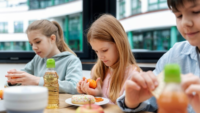 school children at lunch table