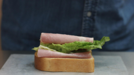 sliced deli meat on bread with lettuce