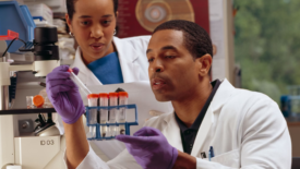 two lab techs looking at test tubes