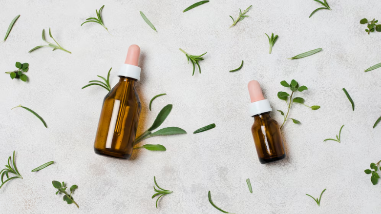 vials of essential oils surrounded by bits of green plants