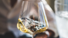 white wine swirling in glass