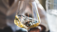 white wine swirling in glass