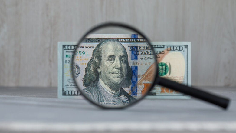 $100 bill under magnifying glass