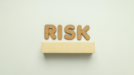 corkboard letters spelling risk