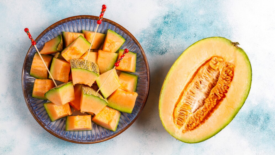 diced cantaloupe next to half of cantaloupe melon