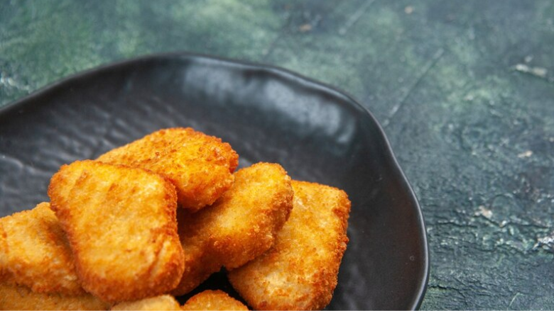 frozen chicken nuggets that have been cooked served on a plate