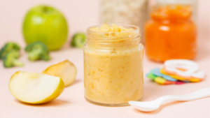 jar of baby food next to apples and broccoli