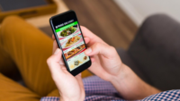 person looking at food delivery app on phone