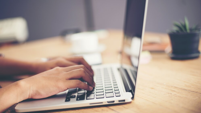 person using a laptop to access a resource