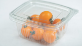 yellow cherry tomatoes in single-use plastic container