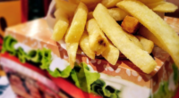 fast food burger in a box with fries on top