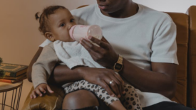 father feeding a baby from a bottle