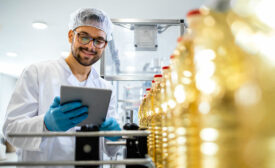 person inspecting bottles of oil