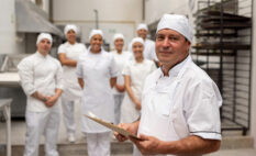 group of employees in production area leader in forefront