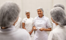 food manufacturing workers training and smiling